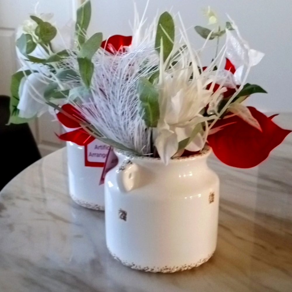 Artificial christmas floral arrangement and vase